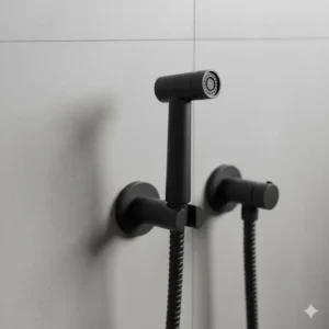 Stainless steel matte black bidet sprayer kit mounted on a bathroom wall.